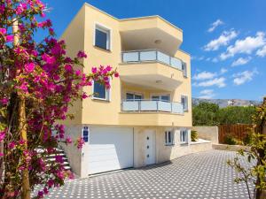 a building with pink flowers in front of it at Villa Rocco Private Saltwater Pool Split in Kaštela