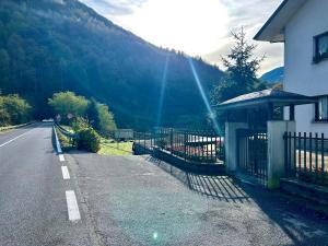 a house on the side of a road next to a mountain at La Farfalla B&B - Mark&Rosy in Malonno +99 photos