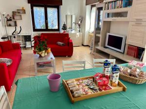 a living room with a table with a tray of food at La Farfalla B&B - Mark&Rosy in Malonno