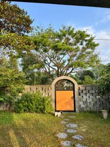 a dog is sitting in front of a door at Te Retreat in Hà My Tây (2)