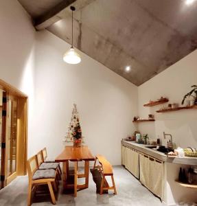 a kitchen with a table and a christmas tree in it at Te Retreat in Hà My Tây (2)