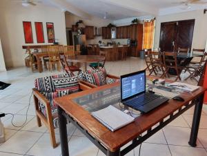 a laptop computer sitting on a wooden table in a room at Chinelos Ixtapa in Ixtapa