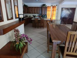 a kitchen and dining room with a wooden table and chairs at Chinelos Ixtapa in Ixtapa +8 photos