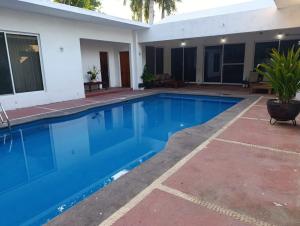 a swimming pool in the backyard of a house at Chinelos Ixtapa in Ixtapa