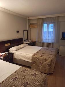 a hotel room with two beds and a window at SPOR HOTEL in Ankara