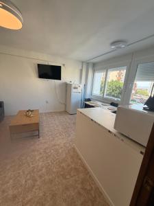 a room with a kitchen with a refrigerator and a table at torremolinos centro parking privado in Torremolinos
