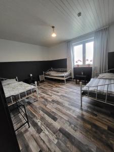 a room with three beds and a large window at Hani's Partyhaus in Verl +27 photos