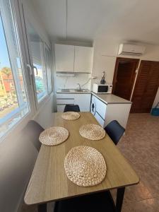a kitchen with a table with two plates on it at torremolinos centro parking privado in Torremolinos