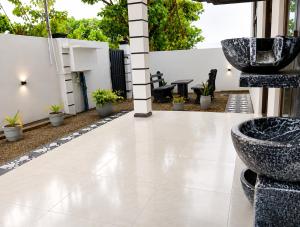 a patio with two large stone bowls on it at Blue Waves Ocean Mirissa in Mirissa