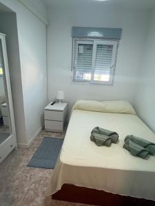 a bedroom with a bed with two bags on it at torremolinos centro parking privado in Torremolinos