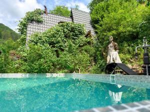 a statue of a woman standing next to a swimming pool at Suputnyk in Rakhiv