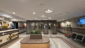 a lobby with a couch in the middle of a building at Johra International Hotel فندق جوهرة إنتر ناشونال in Medina