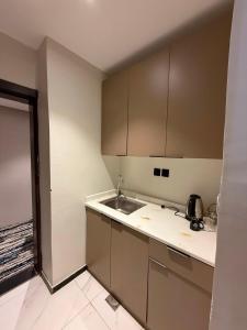 an empty kitchen with a sink and a counter at Johra International Hotel فندق جوهرة إنتر ناشونال in Medina