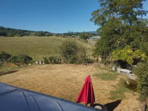 a view of a field from the inside of a tent at Chambre Tarentaise chez les garçons in Saint-Paul-sur-Yenne +3 photos