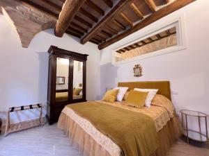 a bedroom with a large bed in a room at Pinturicchio Luxury Suite in Perugia