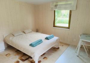 a bedroom with a bed with two pillows on it at Kabakėlio slėnis in Kabakelis
