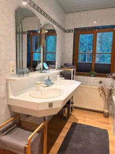 a bathroom with a sink and a large mirror at Ferienhaus Sophia & Ilse in Murau +60 photos