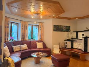 a living room with a brown couch and a table at Ferienhaus Sophia & Ilse in Murau