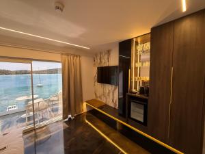 a living room with a view of the water at Hotel BOUTIQUE in Tisno