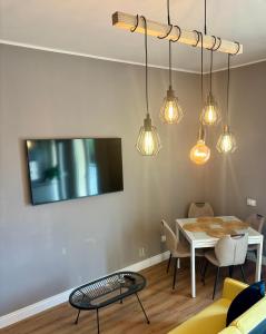 a dining room with a table and a tv at BradAmare Seafront in Montesilvano
