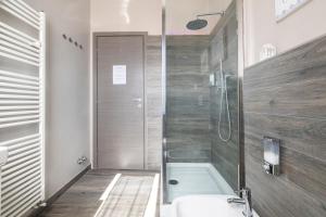 a bathroom with a shower and a bath tub at Da Chiara in Pistoia +18 photos