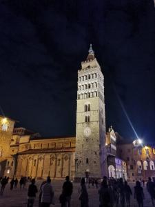 a large building with a clock tower at night at Da Chiara in Pistoia