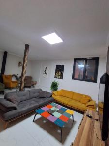 a living room with a couch and a table at Kasabalı OTEL&BUNGALOW in Bulgurca +22 photos
