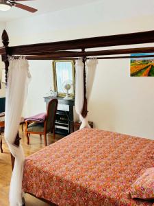a bedroom with a bed and a desk and a table at Maison d'Hôtes Le Cadran Solaire in Courcelles +52 photos