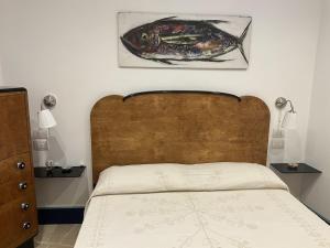 a bedroom with a bed with a fish on the wall at Circumpiso in Massa Lubrense +17 photos