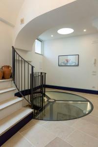 a glass floor in a room with a staircase at Circumpiso in Massa Lubrense