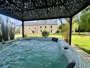 a hot tub in the backyard of a house at L'Escale d'Armorique 2 in Languidic +3 photos