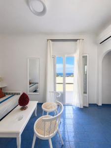 a bedroom with a bed and a table and chairs at Hotel Chiaia Di Luna in Ponza