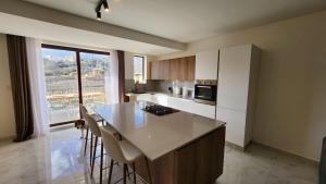 a kitchen with a island with a counter top at Hal Wardija Resort Apartments in Qala