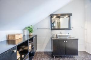 a bathroom with a sink and a mirror at Paul Sun Scape - Seaside Ocean & Sunset View in Paul do Mar +24 photos