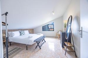 a bedroom with a bed and a desk in a room at Paul Sun Scape - Seaside Ocean & Sunset View in Paul do Mar