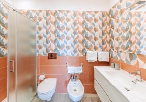 a bathroom with a toilet and a sink at Villetta Mami in Ischia +13 photos