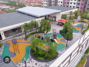 an aerial view of a playground in front of a building at Rumah Suri Homestay at Arena2 Residence Kota Warisan in Sepang