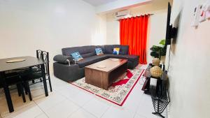 a living room with a couch and a table at 3 bedroom house buxton in Mombasa