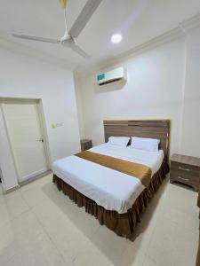 a bedroom with a large bed in a room at رحاب السعاده rehab alsaadah apartment in Salalah
