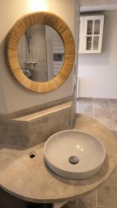 a bathroom with a sink and a mirror at L'atelier in Sugères