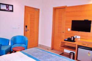 a hotel room with a bed and a television at Hotel Landmark Near Golden Temple in Amritsar +27 photos