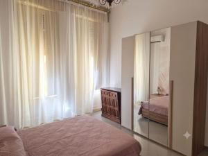 a bedroom with a bed and a dresser and a mirror at Casa mediterranea in Formia