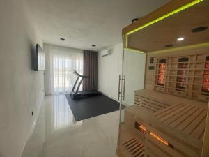 a room with a gym with a treadmill in it at Villa Golden Star in Zaton