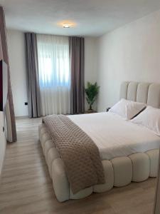 a bedroom with a large bed with a large headboard at Villa Golden Star in Zaton +22 photos