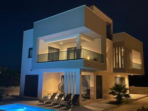 a large house with a swimming pool at night at Villa Golden Star in Zaton