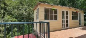 a tiny house with a porch and a balcony at Fursat Exclusive Solitude in Rāmgarh