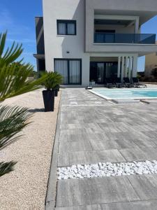 a villa with a swimming pool and a house at Villa Golden Star in Zaton