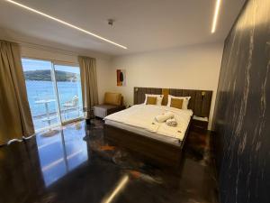 a bedroom with a bed and a view of the ocean at Hotel BOUTIQUE in Tisno