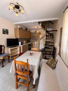 a living room with a table and a couch at Diamanti Stone House in Lafiónas +5 photos