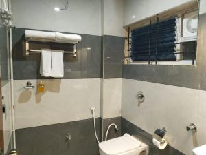 a bathroom with a shower and a toilet and a sink at Emporia comforts in Devanhalli +14 photos